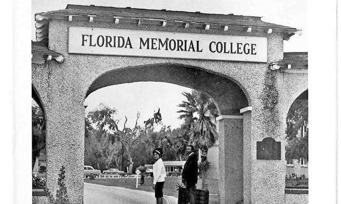 Historical B&W, a male and female student stand under the archway of Florida Memorial College, circa 1930s.