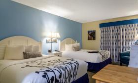 This room with a warm blue wall has room for four guests at Ocean Sands Inn in Vilano