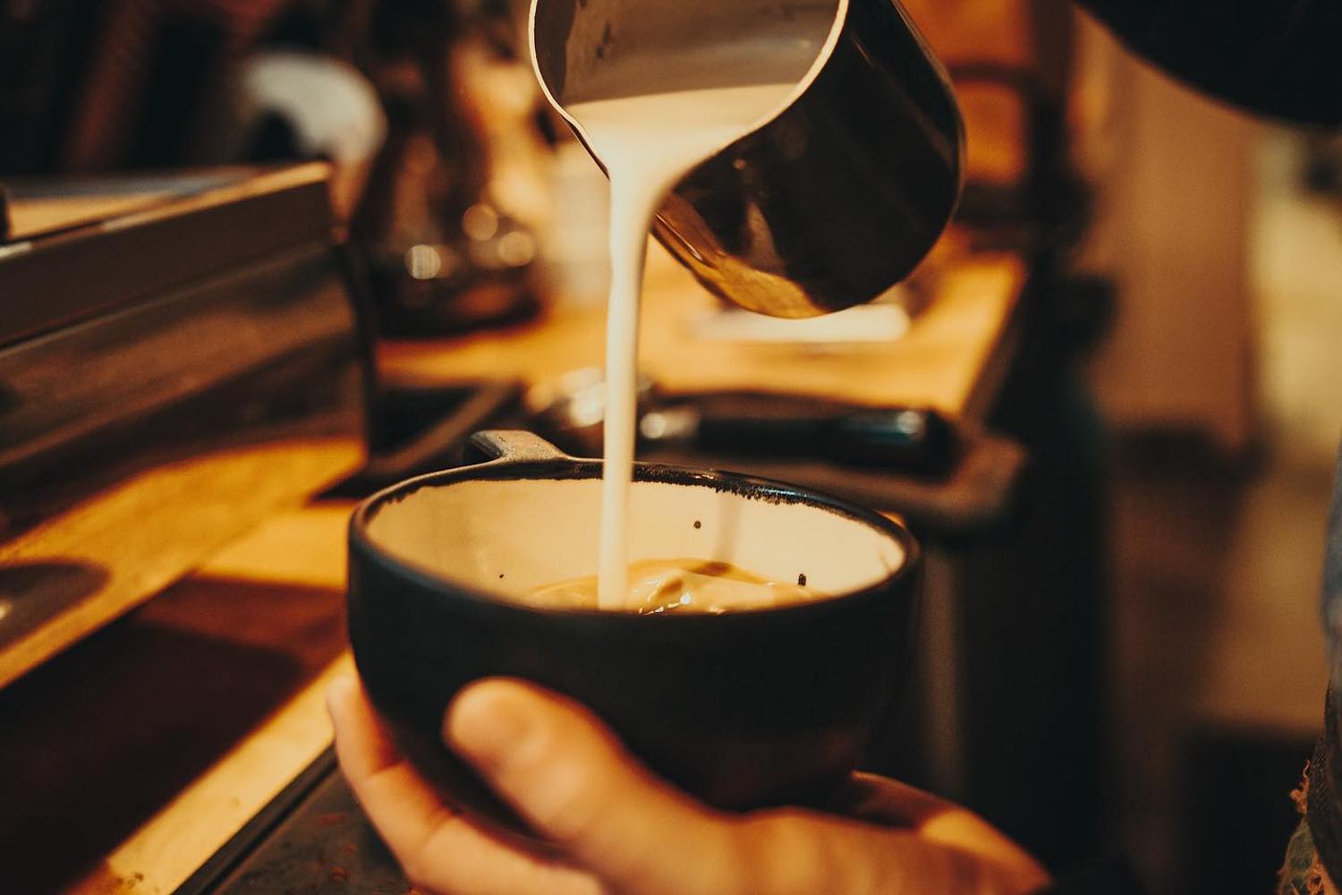 A barista at one of St. Augustine's Kookaburra coffee shops, preparing a hot drink for a guest