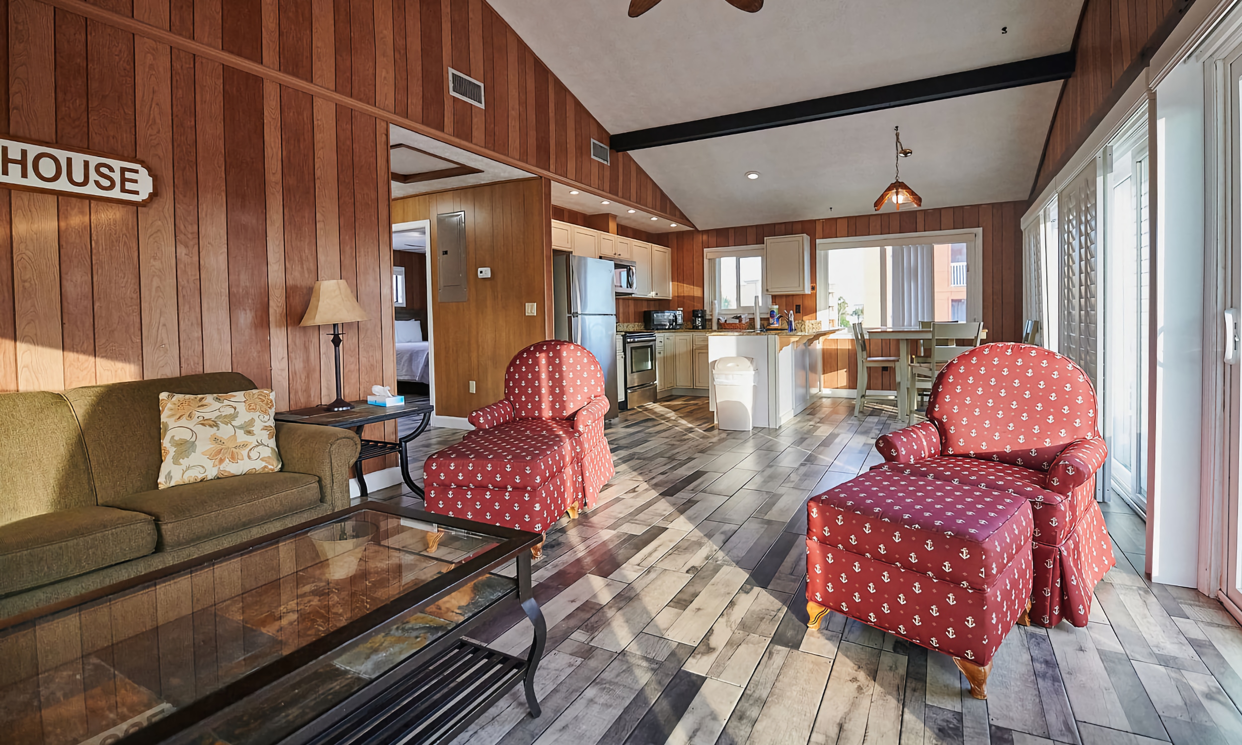 The common sitting area, with doors to the deck, and a communal kitchen, at OceanView Inn on Vilano Beach, St. Augustine