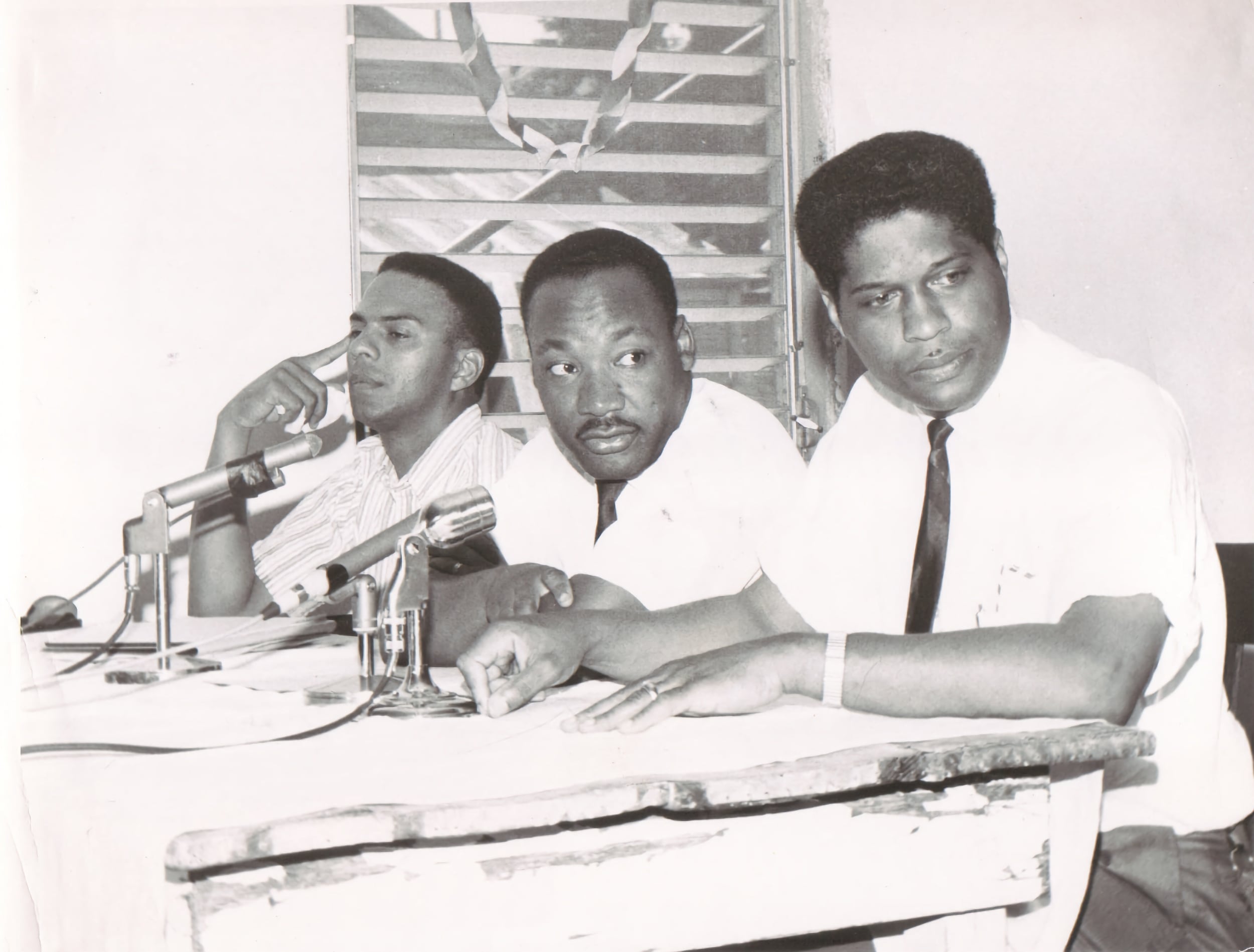 B&W Andrew Young, Dr. MLK Jr., and Dr. R. B. Hayling at a press conference 1964.