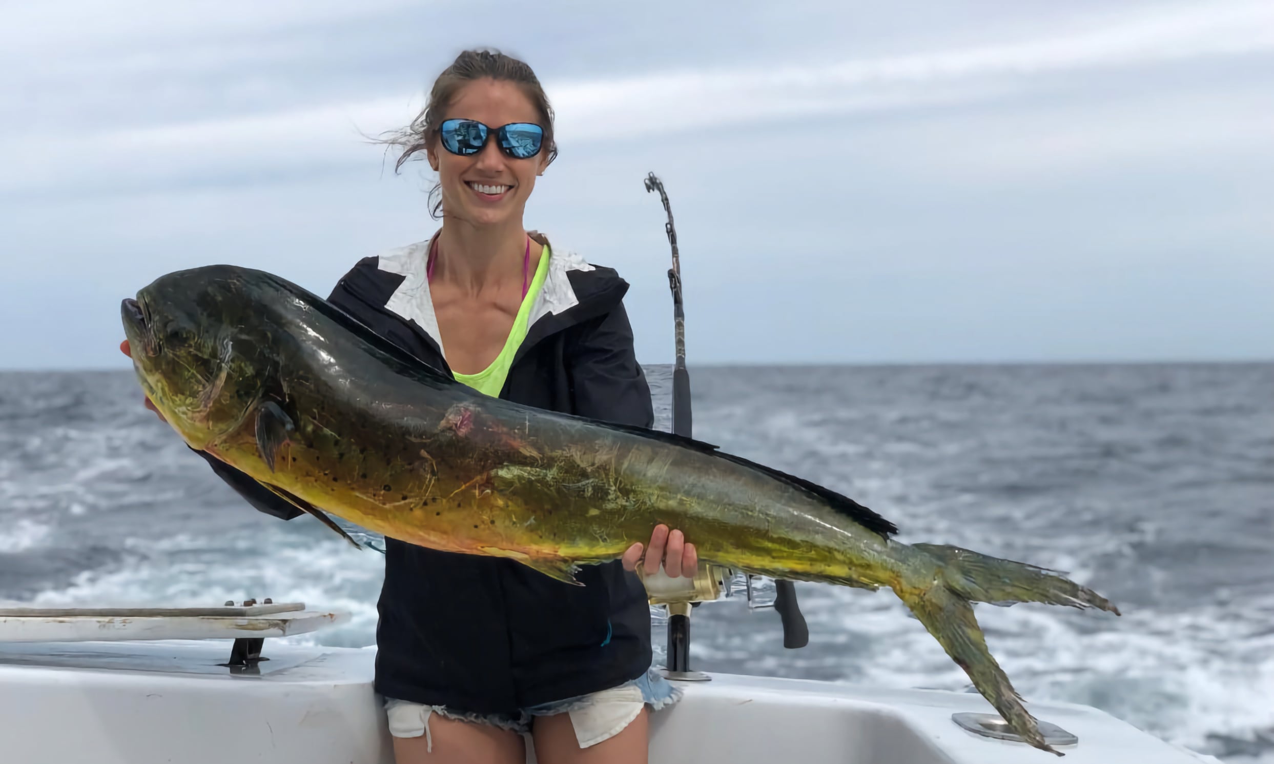 Woman proudly displays her Mahi Mahi catch on the Jodie Lynn charter boat