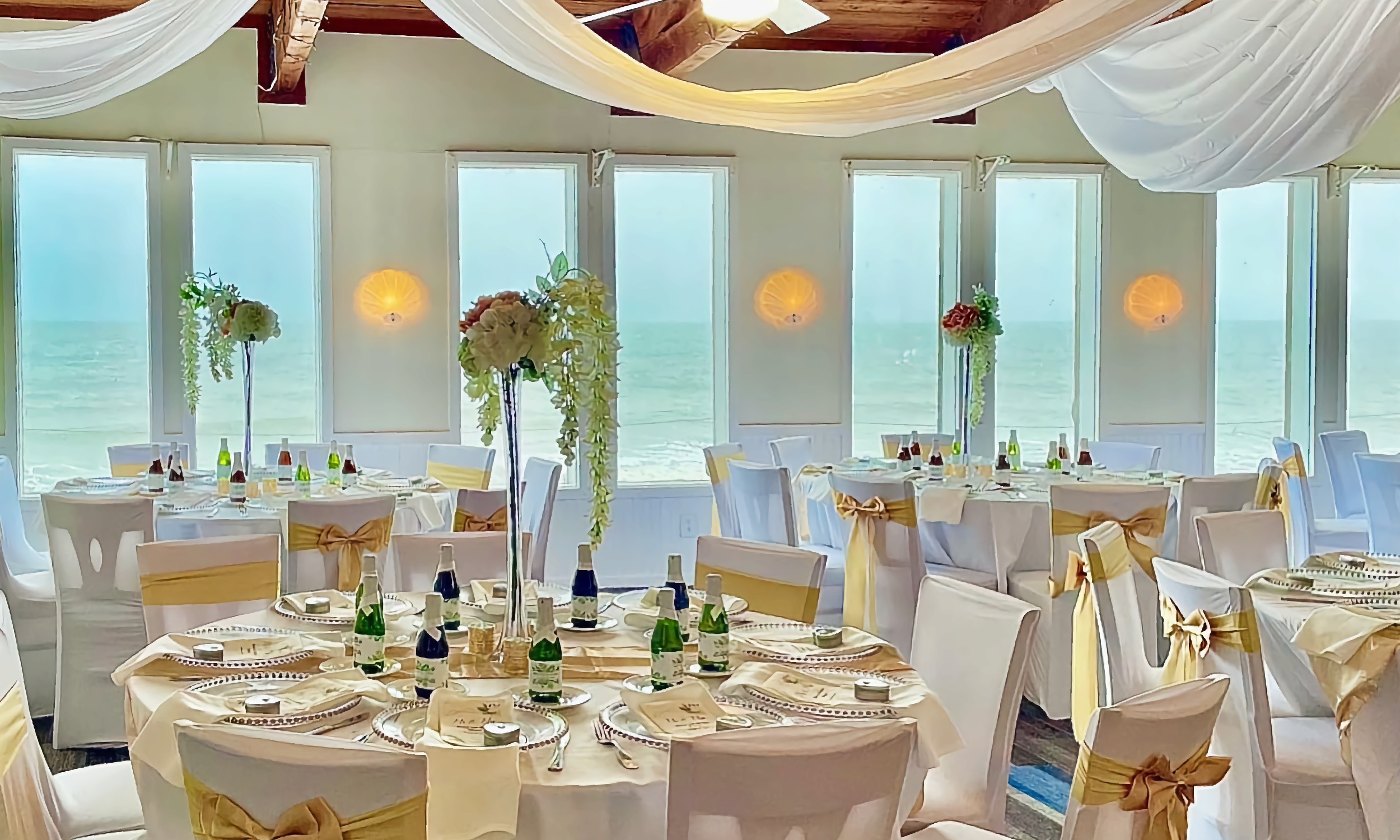 The banquet room at the Reef Restaurant seats 75, here it is set up for a lovely wedding with white draping