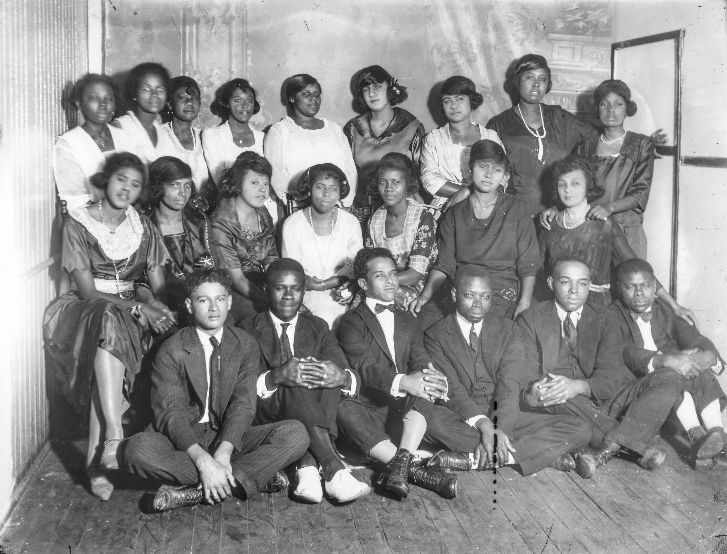 B&W, 22 people, all young Black people dressed for church, pose in three rows.