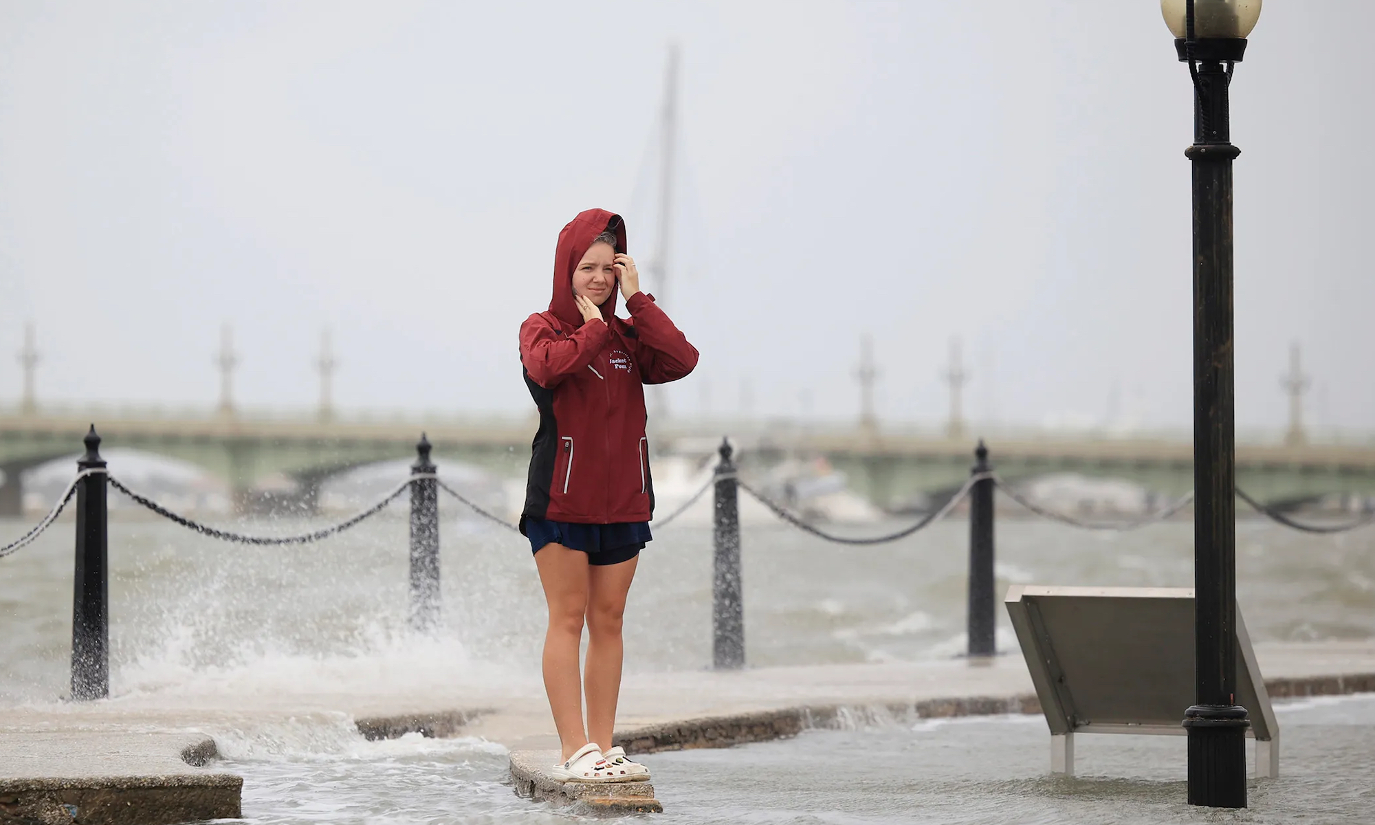 A woman in a rain storm by the bay