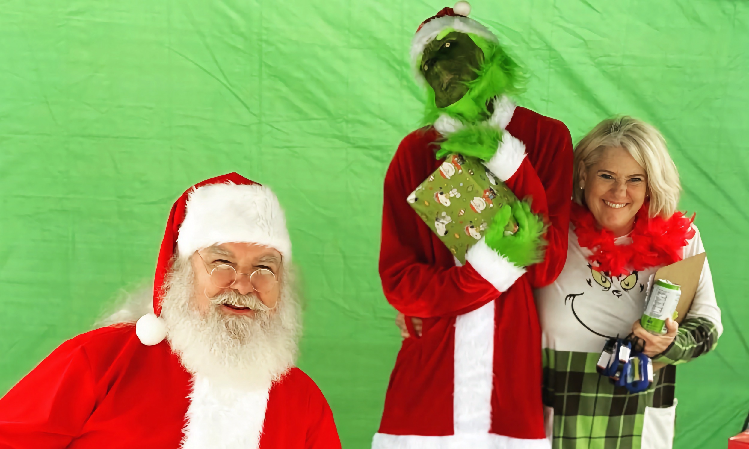 Santa and the Grinch pose for the camera