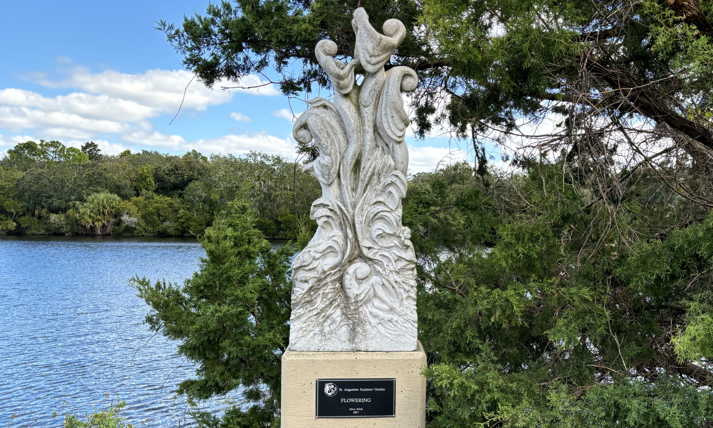 A sculpture next to a lake