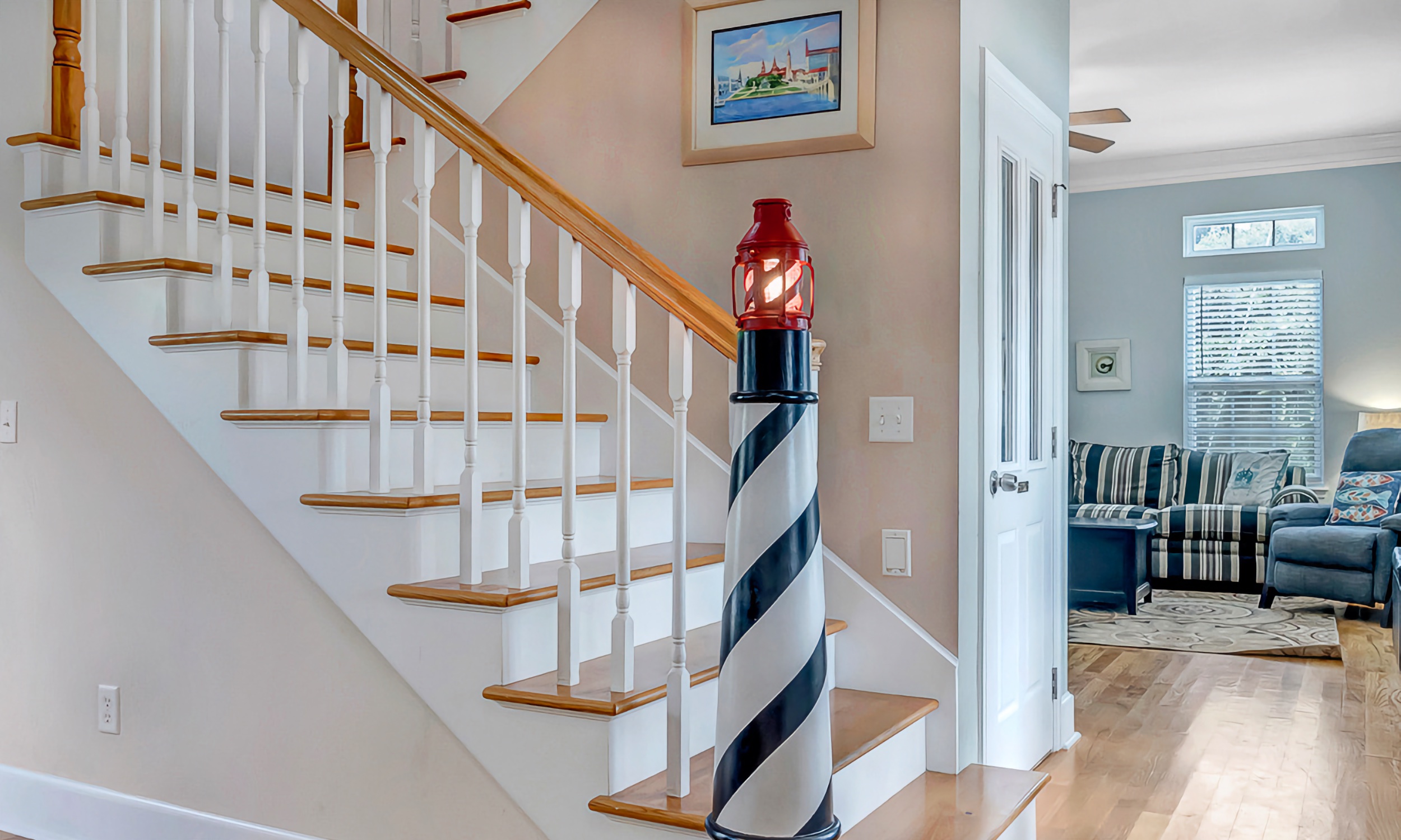 This charmingly decorated home, has a newal post painted and shaped as a lighthouse