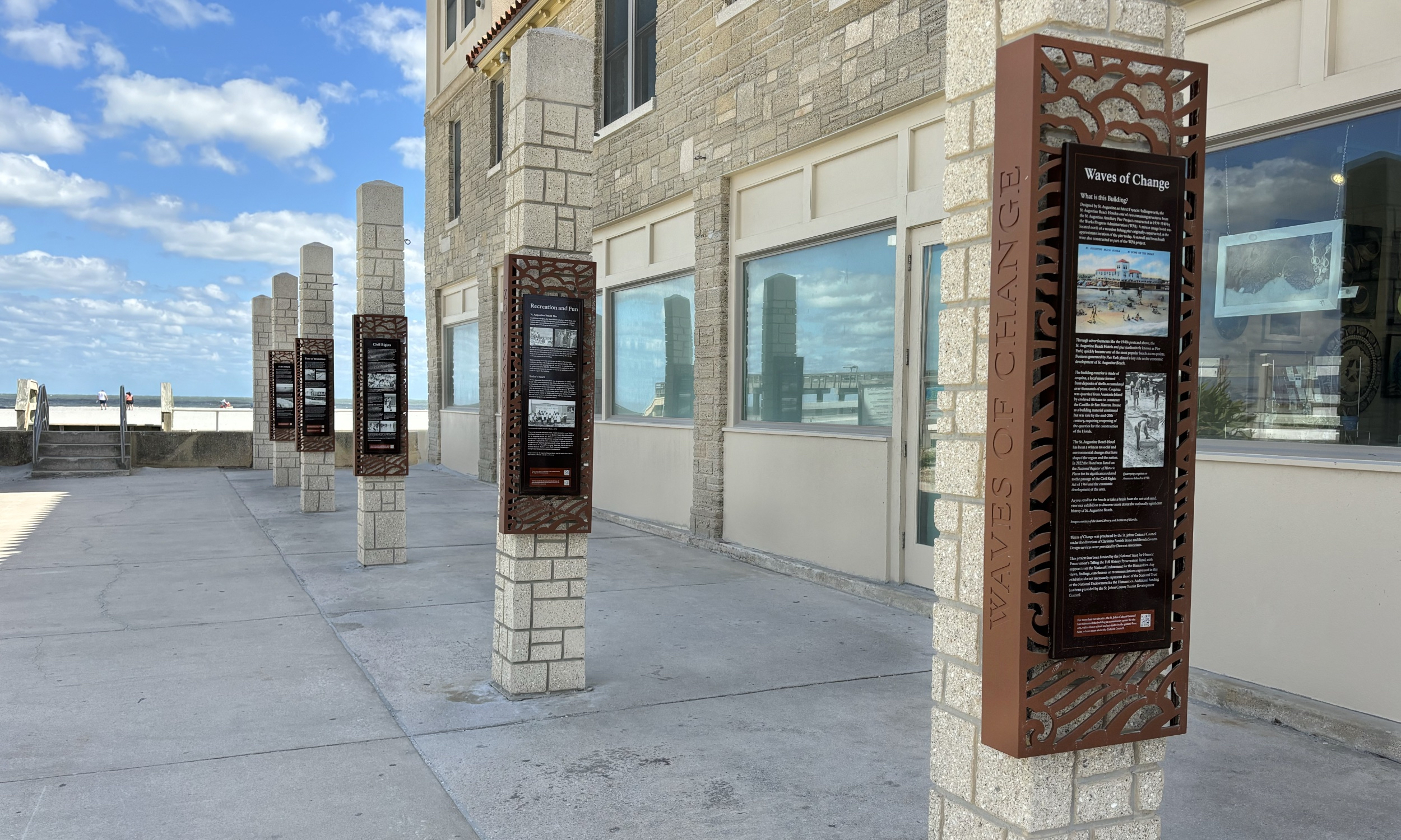 An art installation on pillars next to the beach