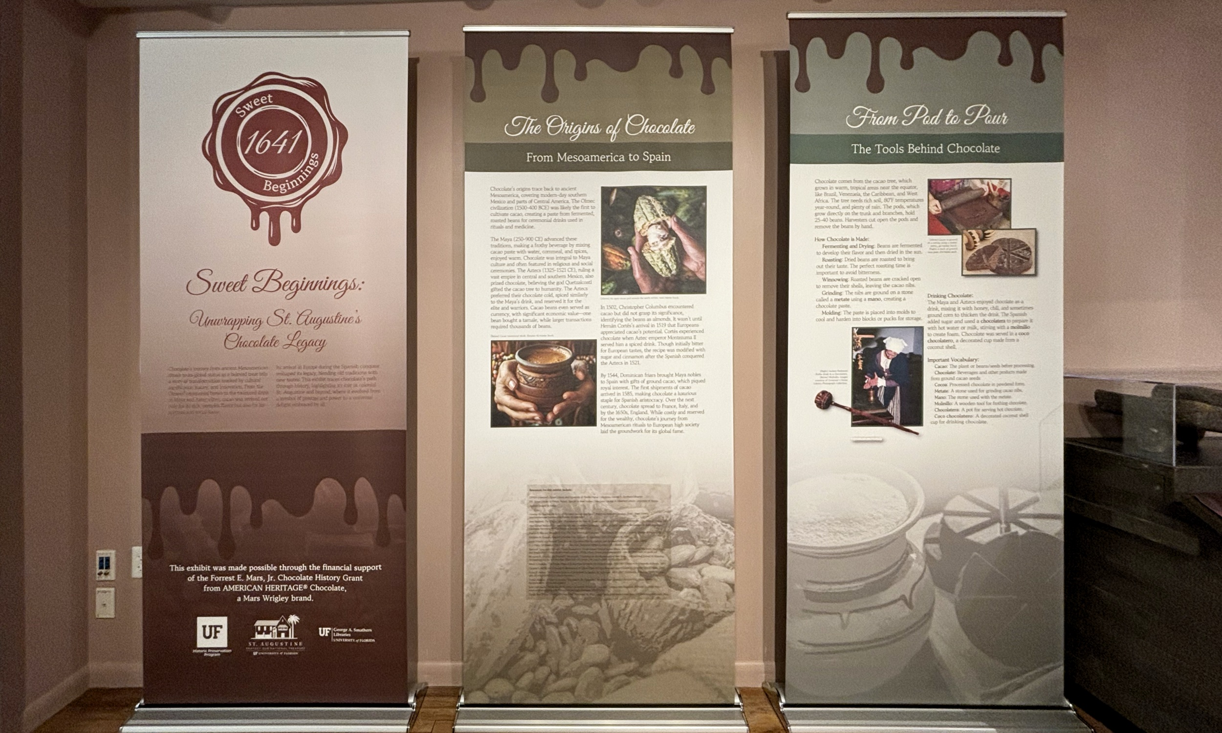 Some of the display panels for a historical exhibit about chocolate, against a milk chocolate-colored wall