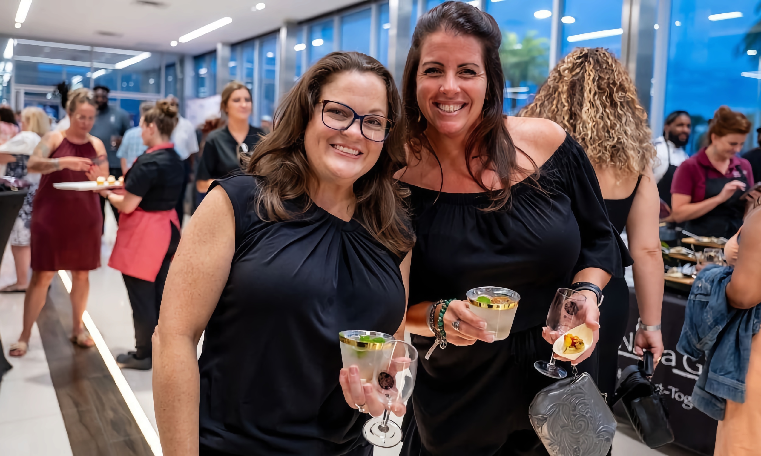 Two women enjoying the tastes at the Harvest Awards and Tastings event