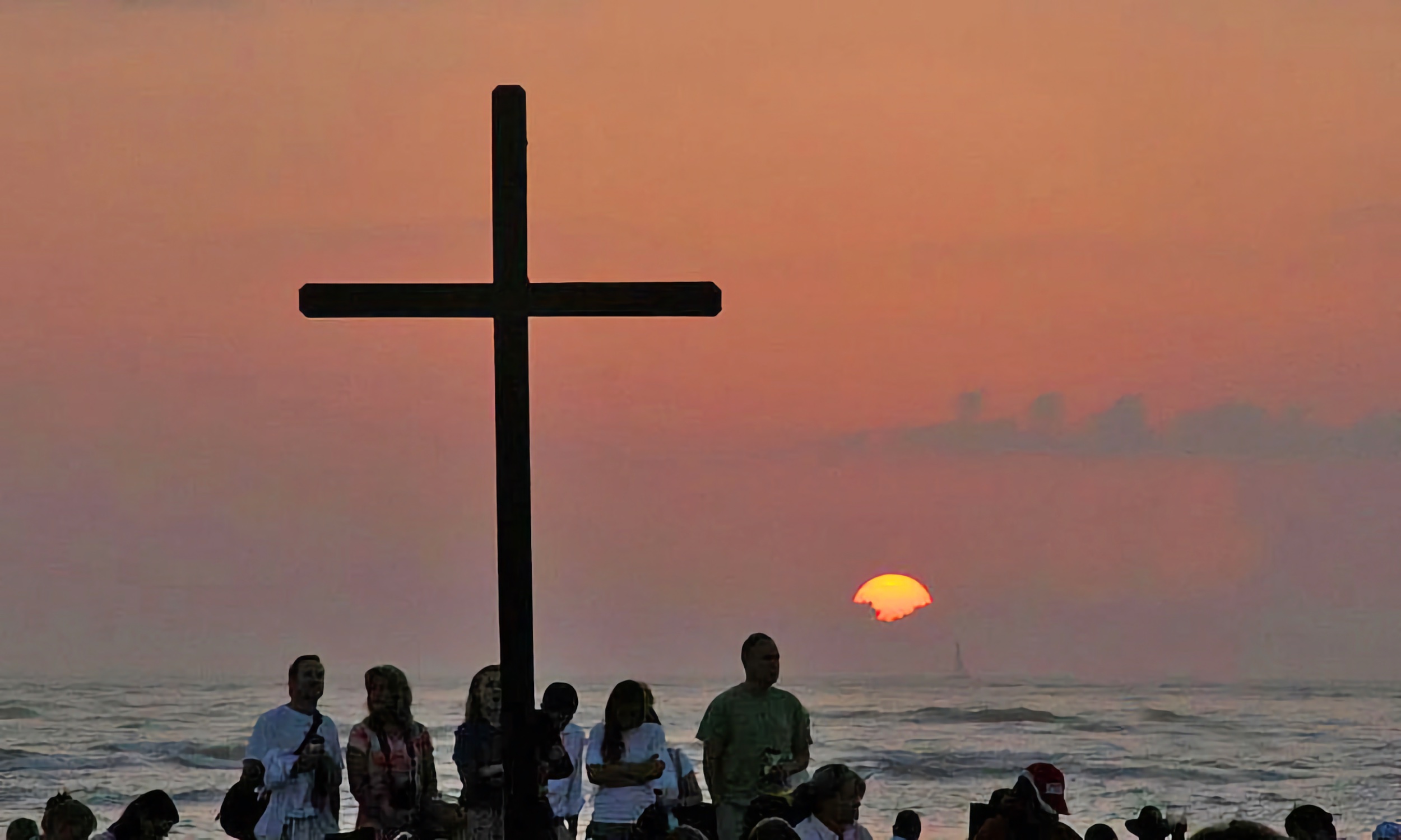 A sunrise church service taking place at the beach