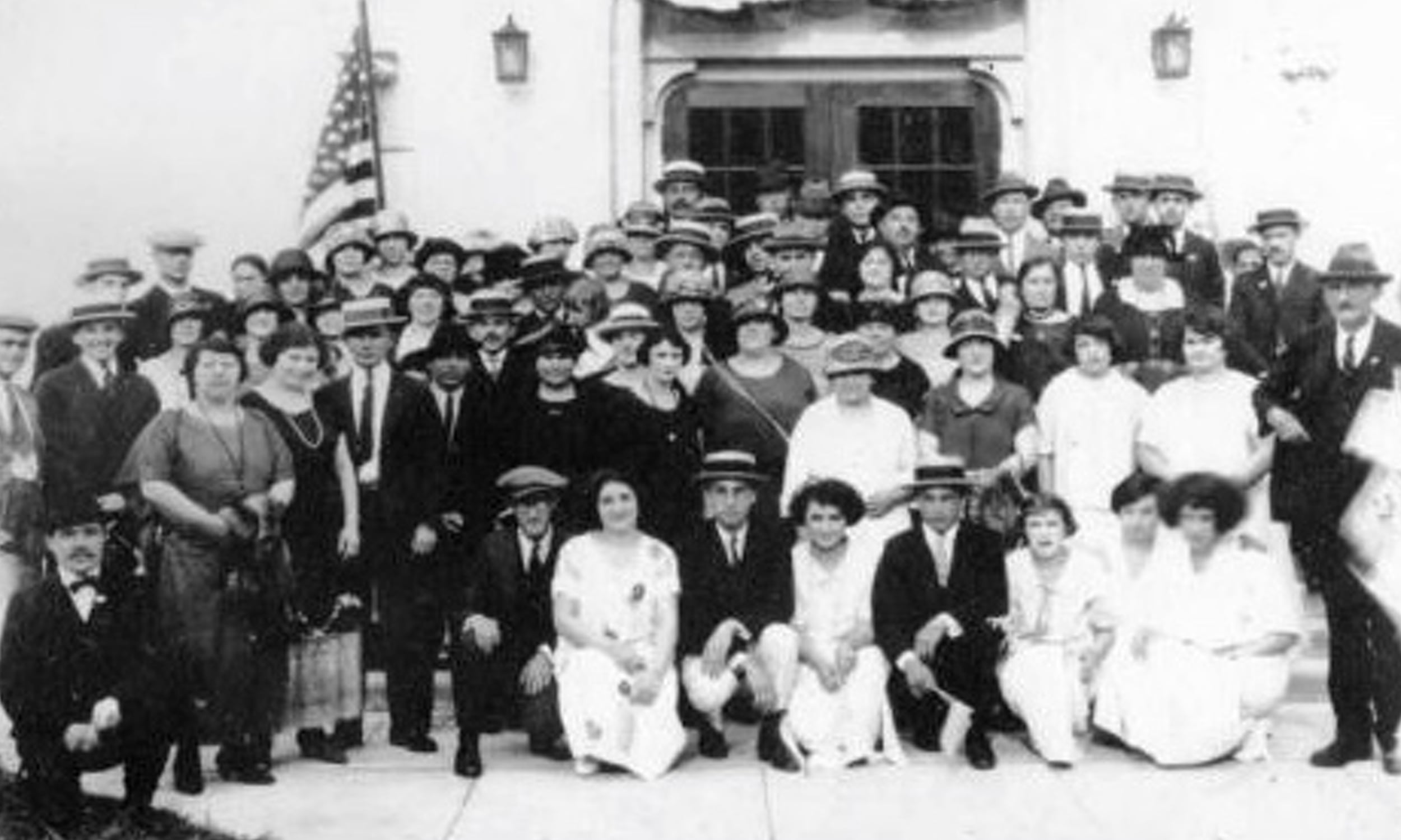 Black-and-white photo of members of the First Congregation Sons of Israel in St. Augustine, gathered in front of the synagogue, dressed in early 20th-century attire