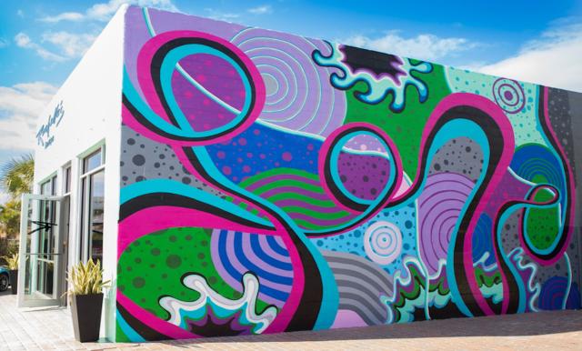 A colorful abstract mural on the side of a building