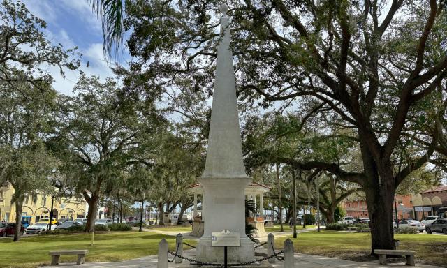 A white obelisk in the park