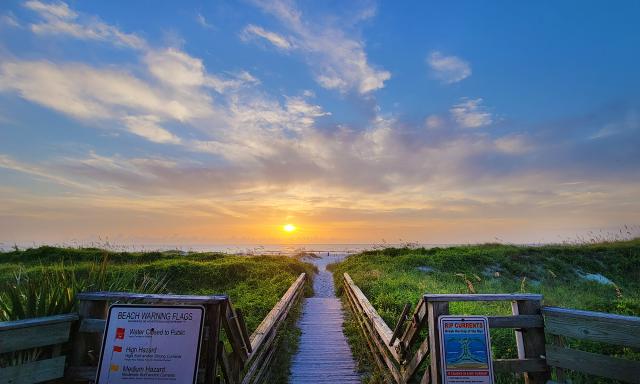 The view of sunrise over the boardwalk at Guy Harvey Resort St. Augustine Beach.