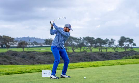 Golfer in his swing at APGA tournament