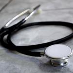 A stethoscope, laying on a marble-patterned counter