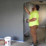 Painter working on interior doorway