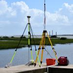 Land surveyors equipment overlooking river