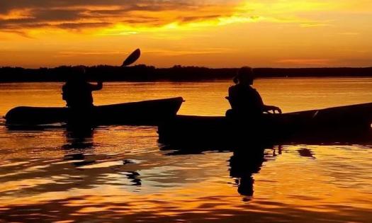 Two kayakers at sunset in St. Augustine