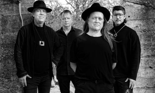 Bandmates from the Violent Femmes pose in a black and white photograph.