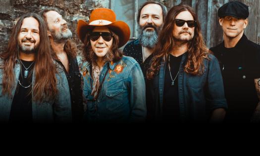 Bandmates from Blackberry Smoke smile and pose in denim jackets. 