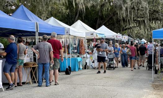 Visitors strolling through the local vendors tents