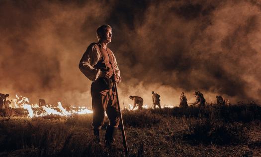 Character, Ludvig Kahlen, standing in a field of flames