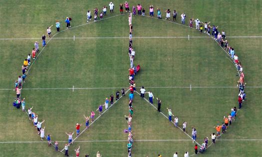 Pie in the Sky Community Alliance celebrates the International Day of Peace with a human peace sign. Photo by Walter Coker.