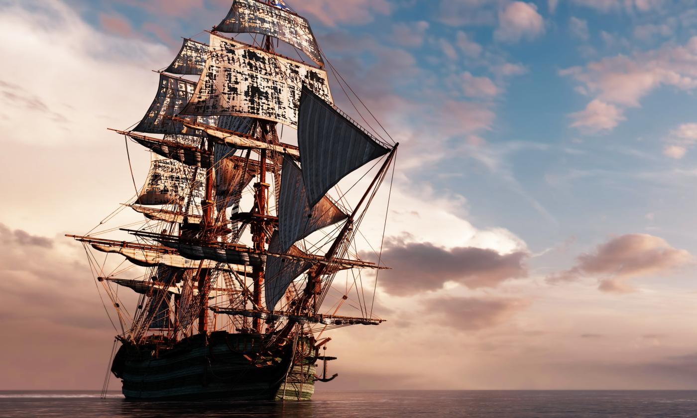 A pirate ship against a blue sky with clouds