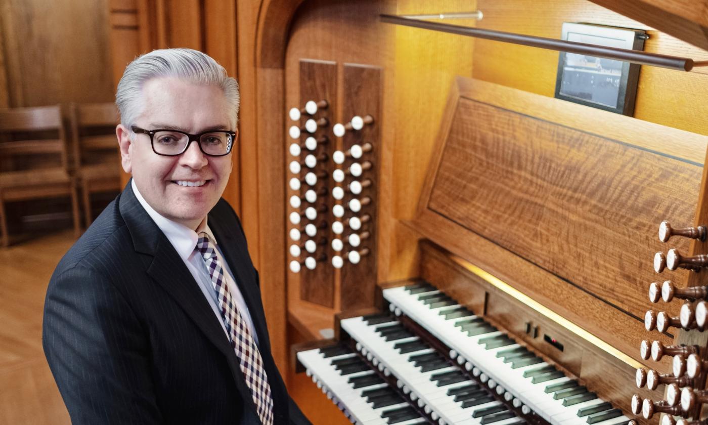 Organist Samuel Metzger seated in front of his organ. 