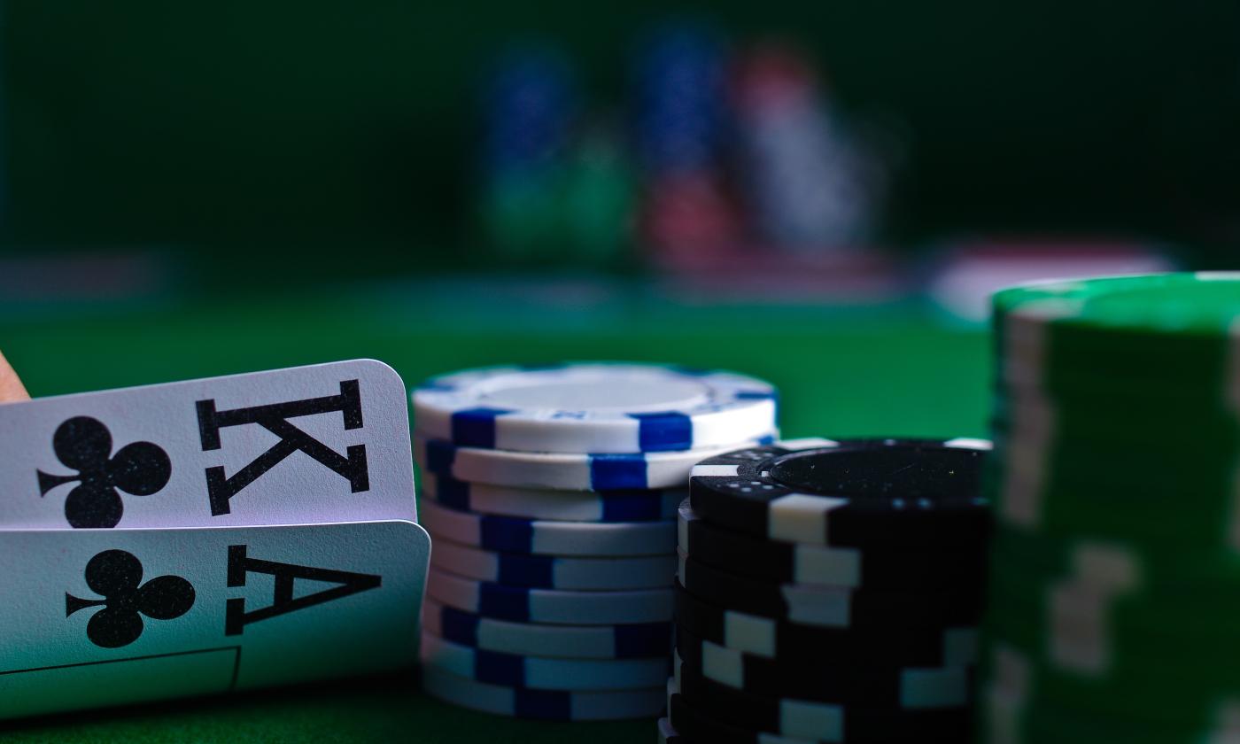 Casino cards and dice are positioned on a casino table. 