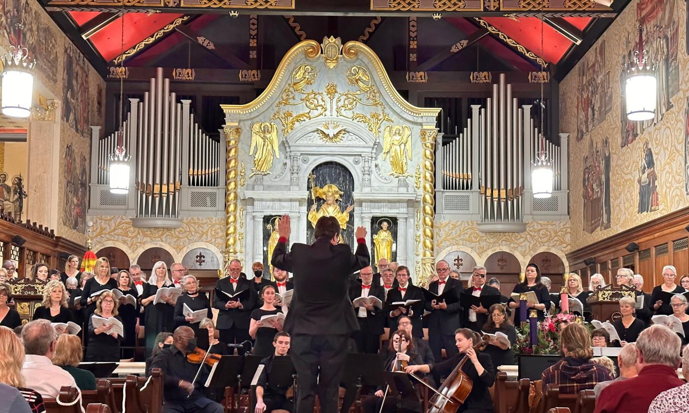 The composer faces the St. Augustine Community Chorus as they perform in the Cathedral Basilica of St. Augustine