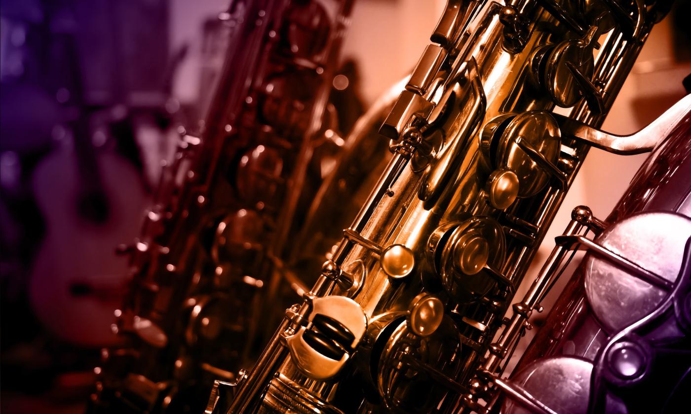 A group of saxophones leaning and ready for a performance.