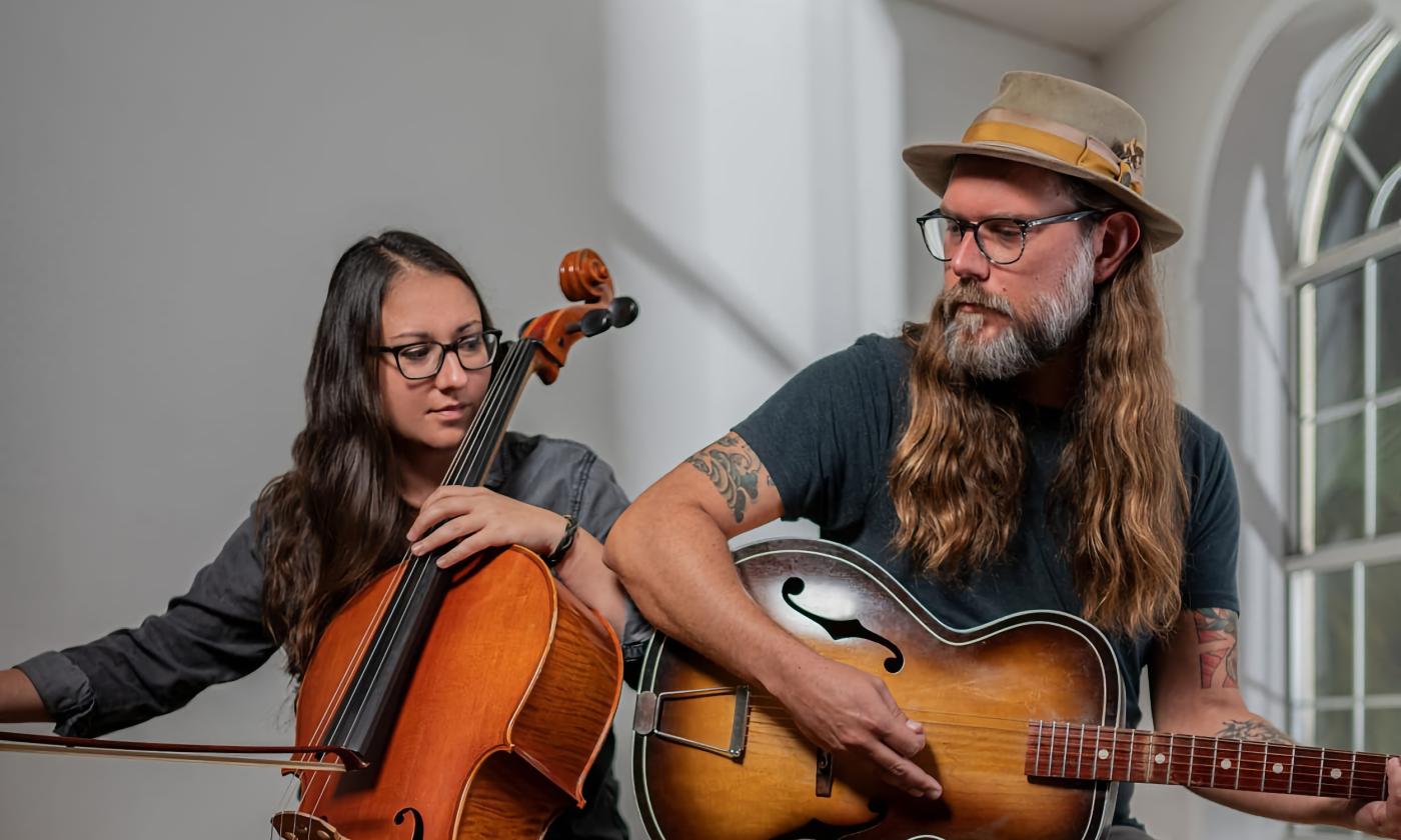 The duo Sweet Sweet with cello and guitar in a white room