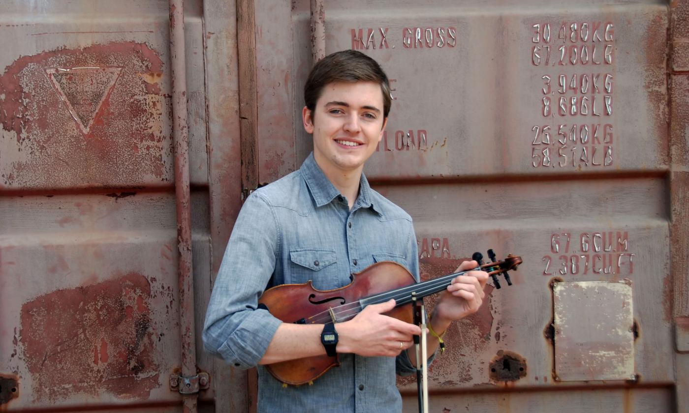 Fiddle player Christina Ward smiling and holding his fiddle