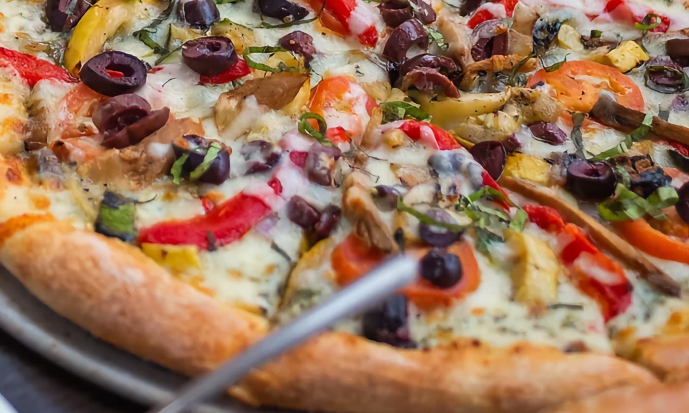 A pan of pizza with a variety of toppings