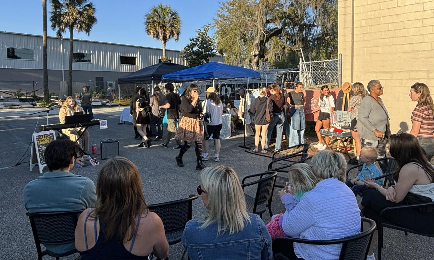 People gather to listen to live music at the market