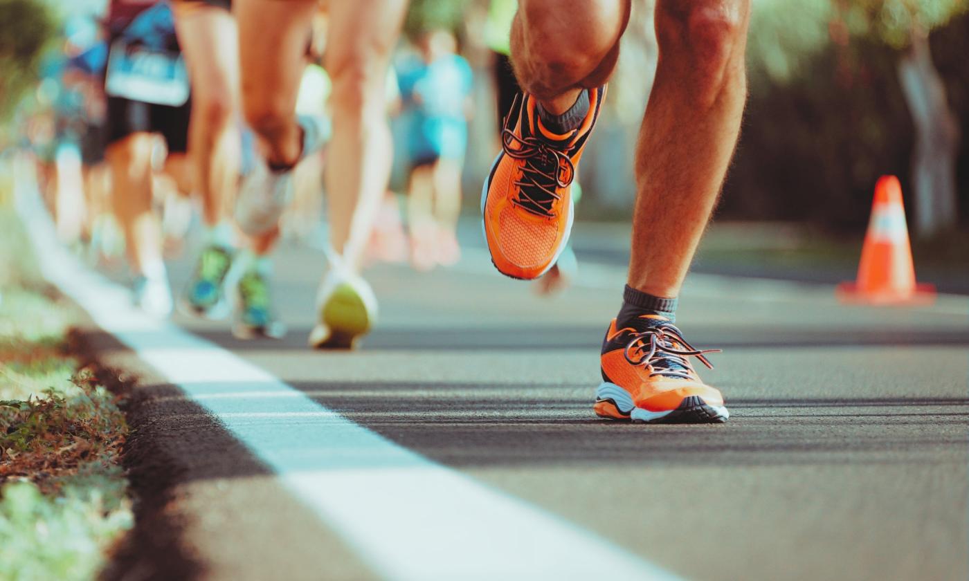 Runners racing along coned road course