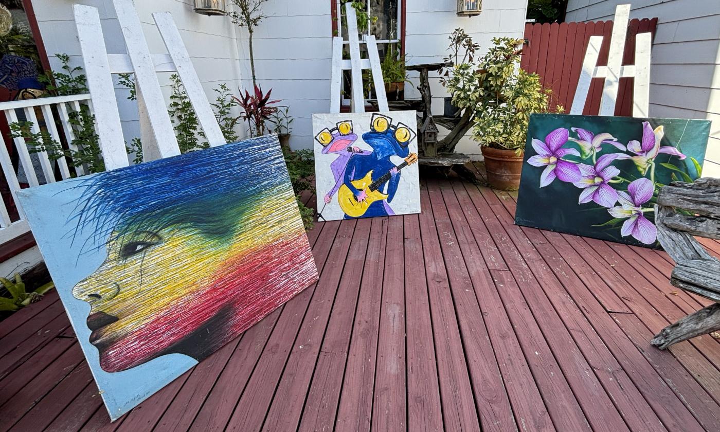 Art canvases displayed on the shop's patio