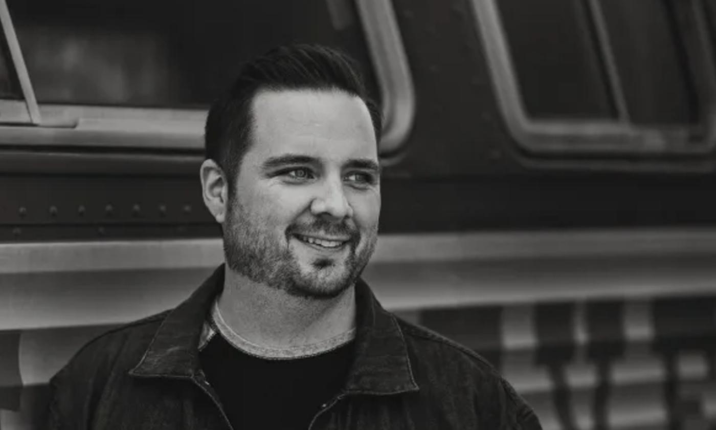 Nashville artist Justin Morgan standing in front of a bus