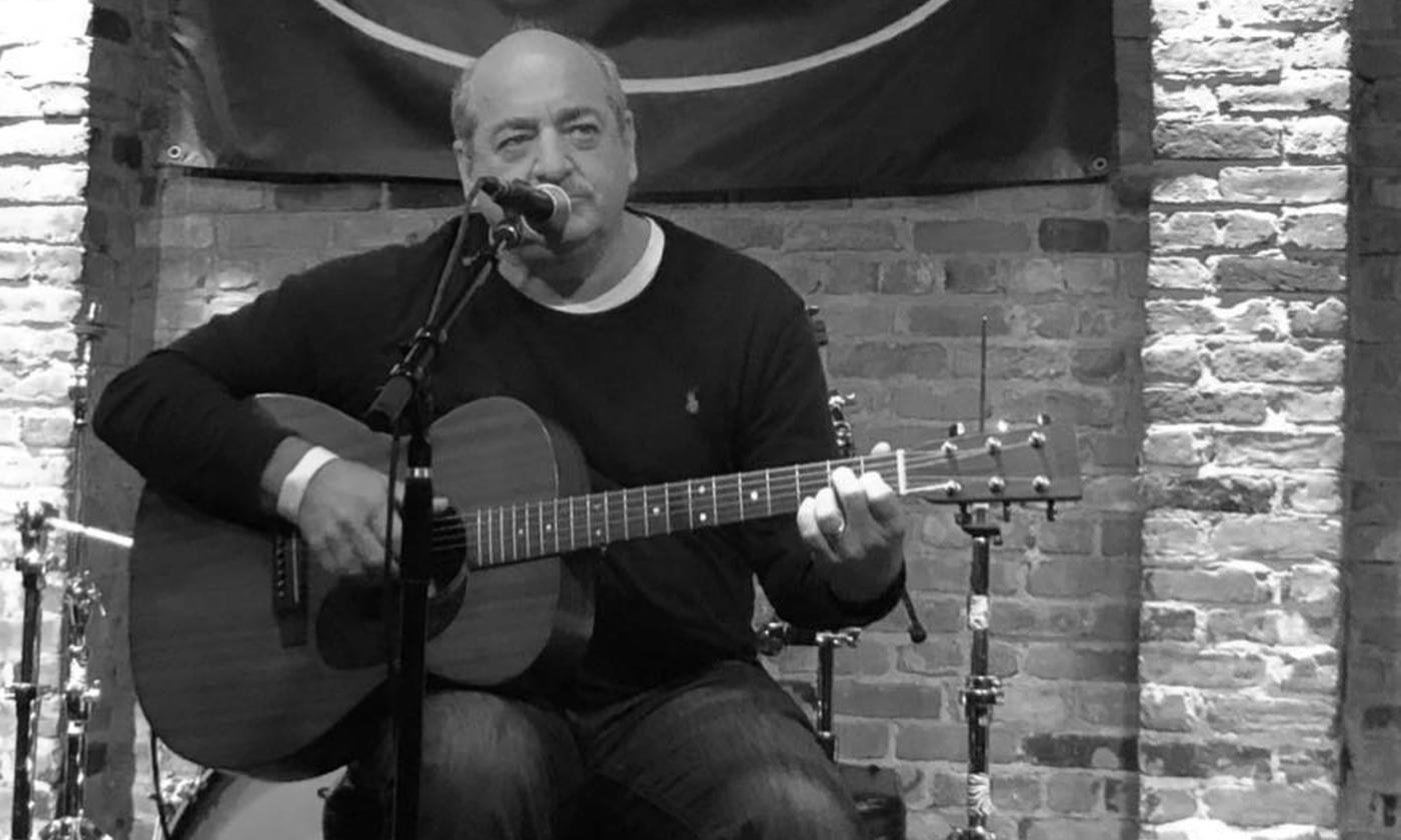 Steven Dale Jones singing with his acoustic guitar