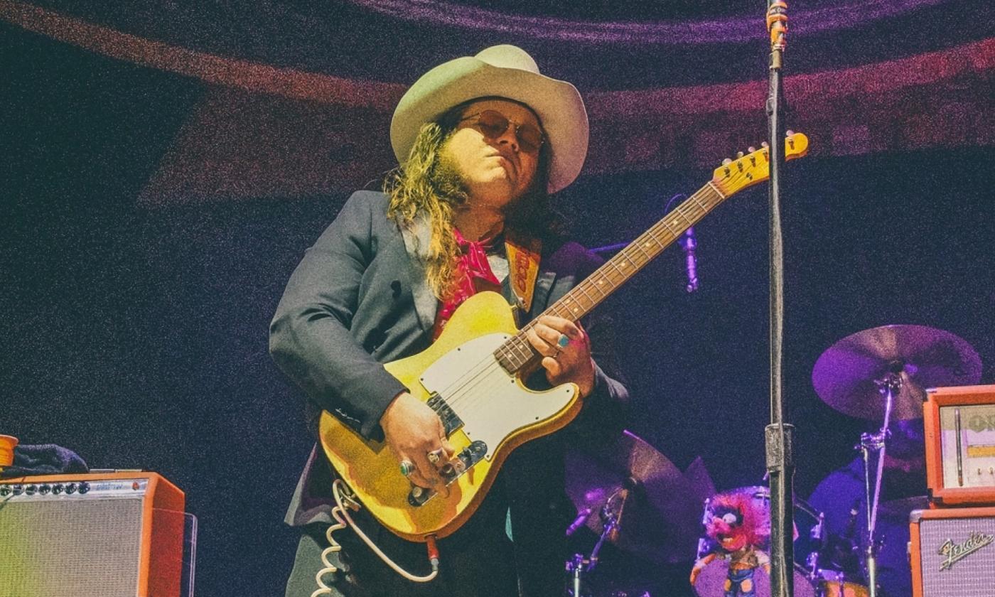 The young artist playing a guitar live