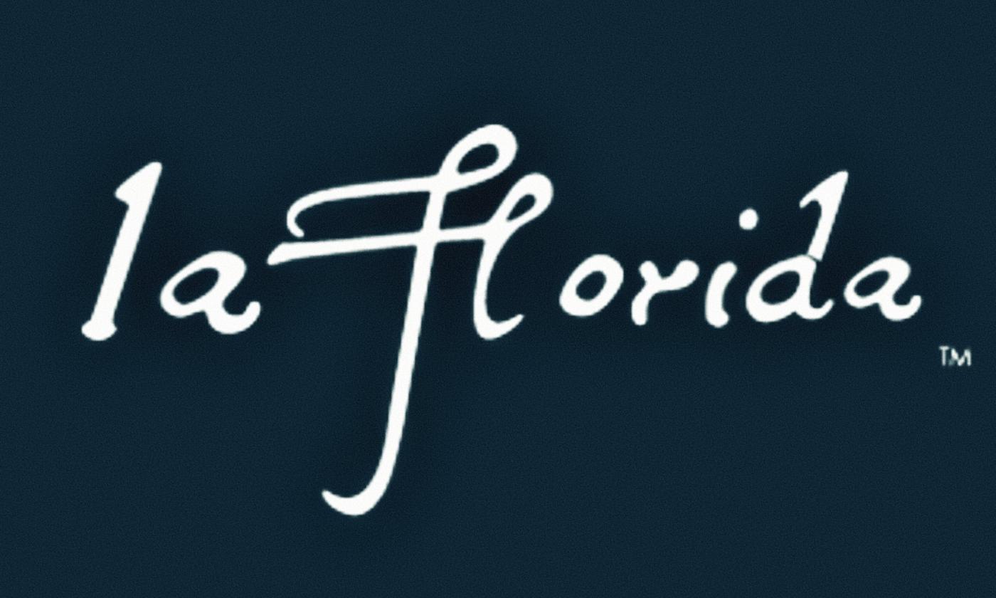 Dark blue BG, white cursive text reading "la Florida (tm)"