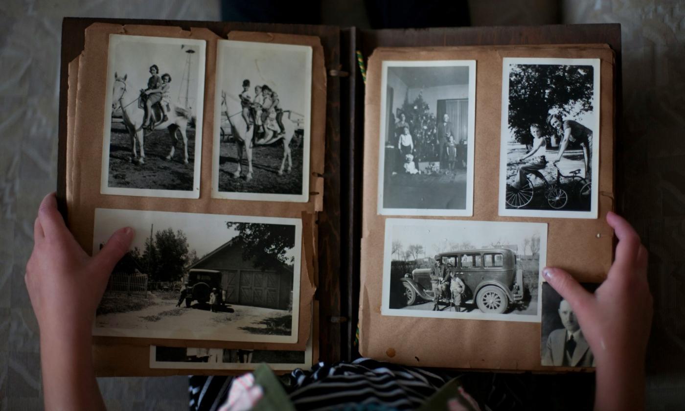 A woman turns the pages of her family album. 