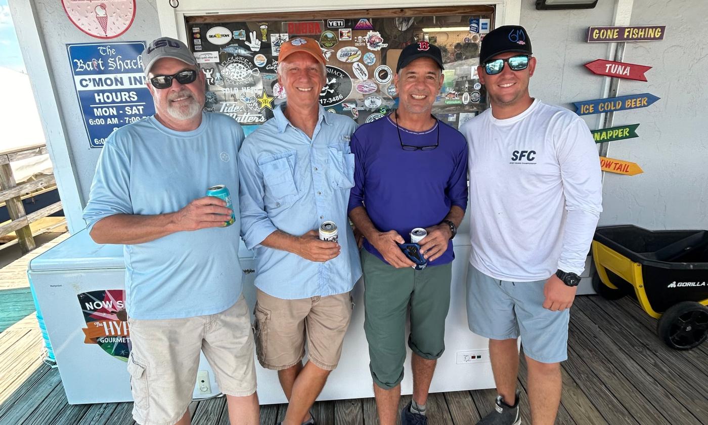 A group of men in Vilano posing for after their fishing charter tour