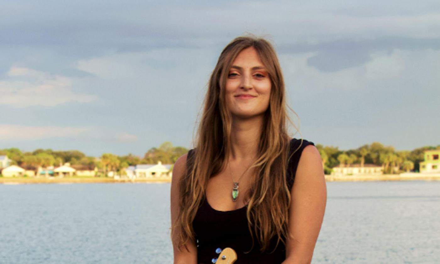 Musician Shyla Macaluso, smiling, at the beach