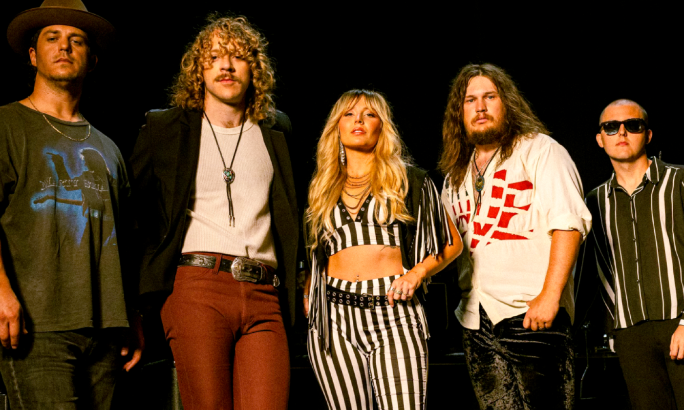 Bandmates from Parker Barrow pose in front of a black backdrop.