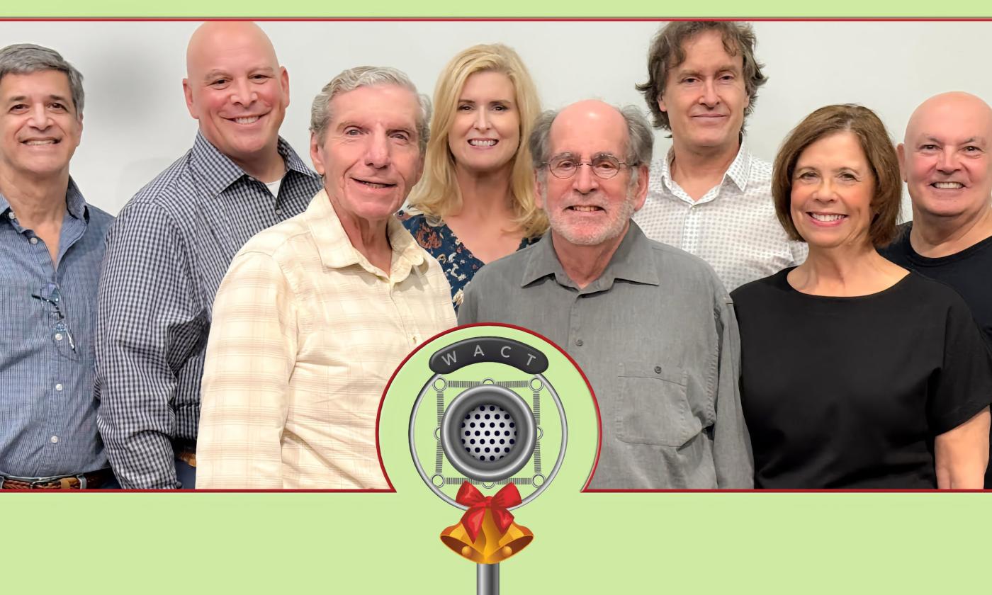 Eight actors posing at an old microphone